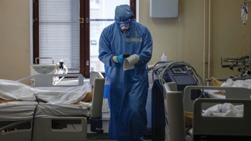 TOPSHOT - A medic wearing personal protective equipment (PPE) works in the intensive care unit for ...