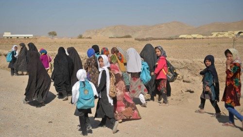 Afghan girls return to their homes after attending school in Chashma Dozak area of Badghis province ...