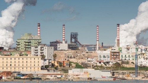 White smoke going up from the chimney of steel plant of  Taranto, Puglia. Italy