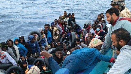 Migrants on a rubber dinghy are seen being rescued by Libyan Coast Guards in the Mediterranean Sea, ...