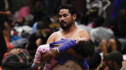 Migrants rest in a park as they head to Mexico City to request asylum as refugees, in Huehuetan, ...