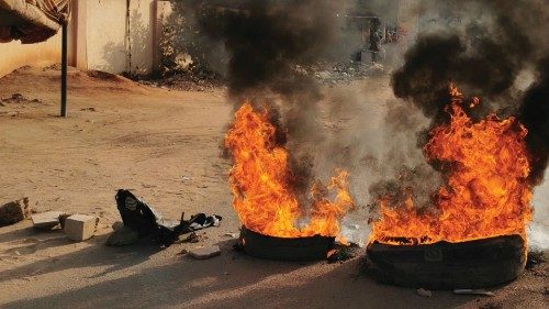 A road barricade is set on fire during what the information ministry calls a military coup in ...