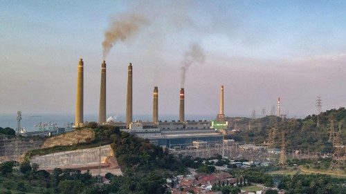 This photo taken on September 21, 2021 shows village houses as smoke rises from the chimneys at the ... This photo taken on September 21, 2021 shows village houses as smoke rises from the chimneys at the ...