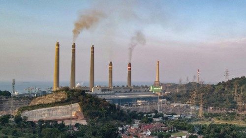 This photo taken on September 21, 2021 shows village houses as smoke rises from the chimneys at the ...