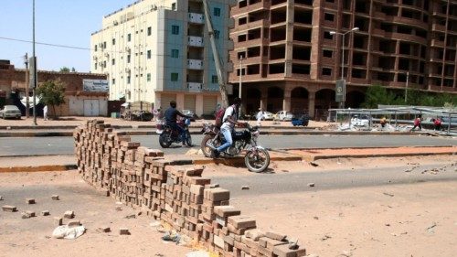 Sudanese anti-coup protesters use bricks to barricade a street in the capital khartoum on October ...