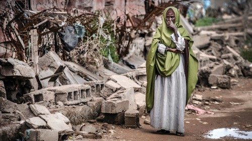 A woman reacts while looking at the destruction left after heavy rains and floods in the school in ...