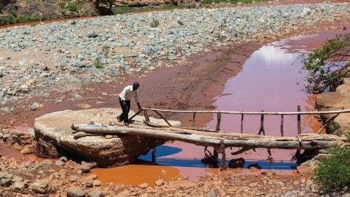 People cross a destroyed bridge outside the Tanganda Rural Health Centre near Mutare, Zimbabwe, Feb, ...