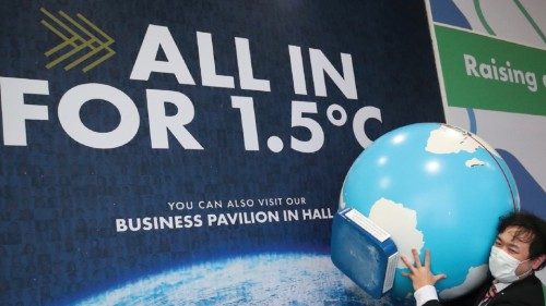 A person carries a globe model during the UN Climate Change Conference (COP26) in Glasgow, Scotland, ...