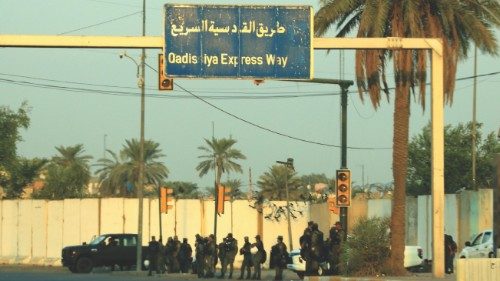 epa09571574 Members of Iraqi security forces take up position at the entrance entrances of the ...