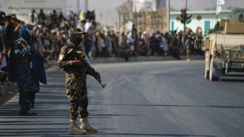 People watch a Taliban military parade of the Al-Badr unit in Kandahar on November 8, 2021. (Photo ...