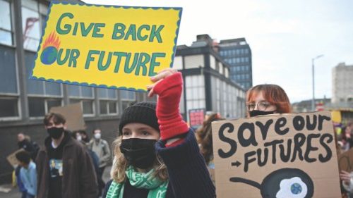 Young protesters hold up placards as they take part in the Fridays For Future rally in Glasgow, ...