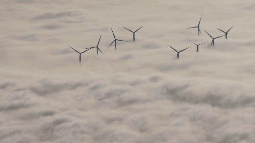 TOPSHOT - Wind turbine are seen over the clouds on November 10, 2021 in Chatellerault, western ...