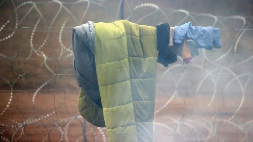 A picture taken on November 11, 2021 shows migrants in a camp on the Belarusian-Polish border in the ... A picture taken on November 11, 2021 shows migrants in a camp on the Belarusian-Polish border in the ...