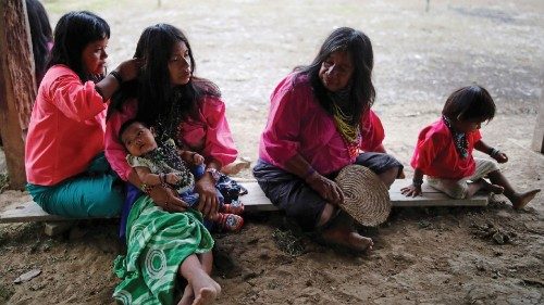 Women take care of children underneath a building on stilts during an outreach by healthcare workers ... Women take care of children underneath a building on stilts during an outreach by healthcare workers ...