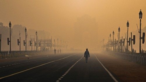 A man walks along Rajpath amid smoggy conditions in New Delhi on January 28, 2021. (Photo by Jewel ...