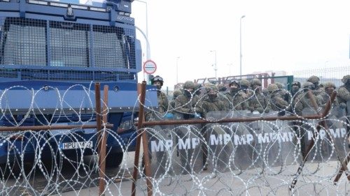 A view from the Belarusian side of the border with Poland shows Polish military police standing ...