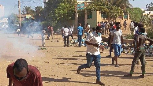 Sudanese anti-coup protesters run for cover from tear gas fired by security forces amid ongoing ...