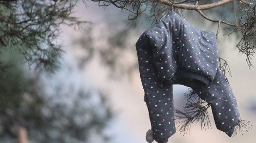 A child's clothing hangs on a tree in the empty migrants' camp near the Bruzgi - Kuznica checkpoint ...