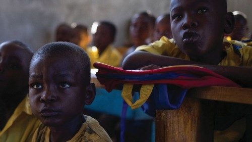 Children sit in close quarters inside a classroom with over sixty students at the St. Michael ...