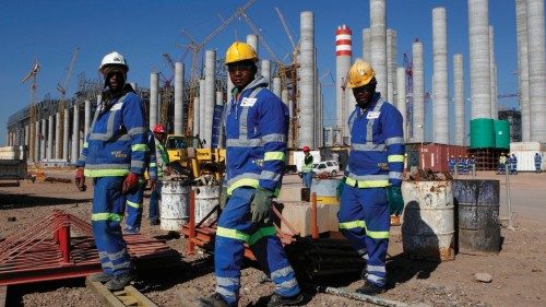 Workers are seen in front the construction site of Eskom's Medupi power station, a new dry-cooled ...