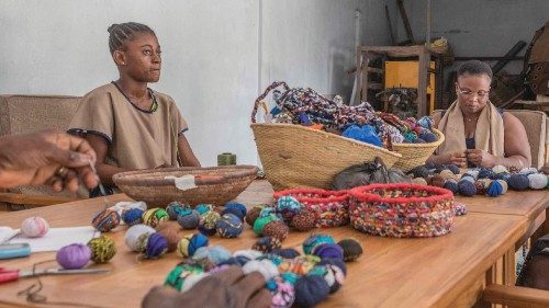 Marcel Adjanohoun, head of several hotels in Ouidah, holds items made at Colour Indigo workshop, a ...