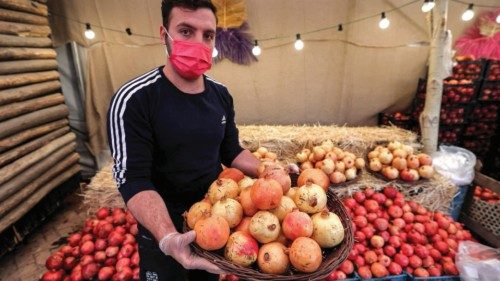 A man holds a basket of pomegranates during the Pomegranate Festival in Iran's capital Tehran on ...