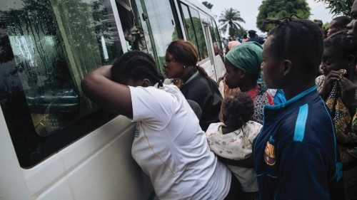 TOPSHOT - Central African refugees cry as their relatives and friends are bussed from Inke camp to ...