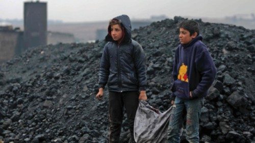 Syrian boys transport coal as they work at a makeshift oil refinery near the Turkish-controlled ... Syrian boys transport coal as they work at a makeshift oil refinery near the Turkish-controlled ...