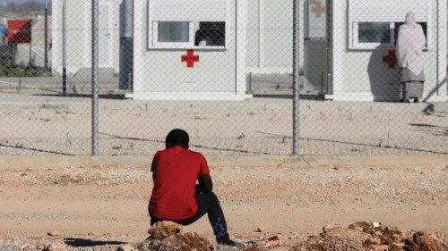 FILE PHOTO: A migrant sits outside the Kokkinotrimithia refugee camp on the outskirts of Nicosia, ...