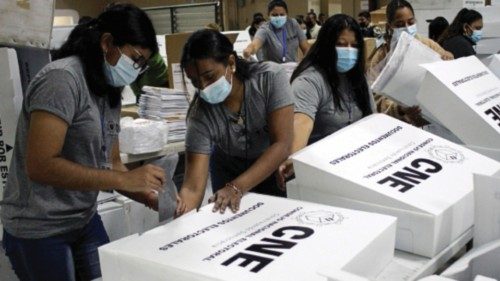 Workers assemble boxes with voting materials for distribution throughout the country ahead of the ...