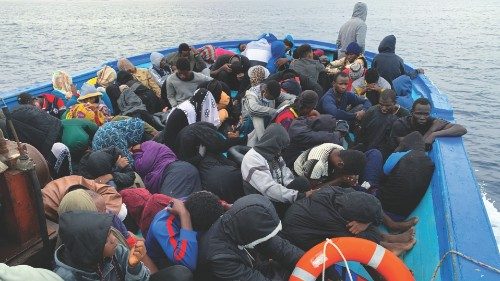 Migrants are seen in a boat as they are rescued by Libyan Coast Guards in the Mediterranean Sea, off ...