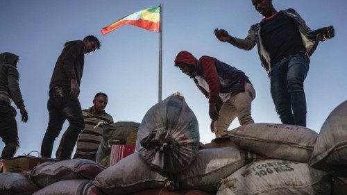 Volunteers load food supplies on the on a truck, destined for troops battling Tigrayan rebels, in ... Volunteers load food supplies on the on a truck, destined for troops battling Tigrayan rebels, in ...