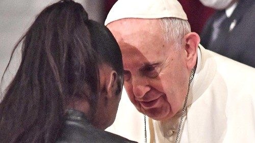 Pope Francis (R) greets a woman during an ecumenical prayer with migrants at the Roman Catholic ...