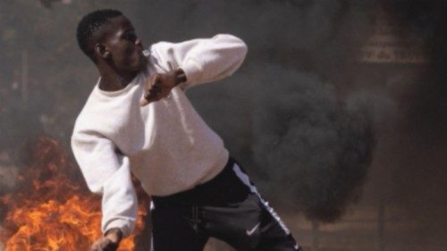 A protestor throw rocks in reaction to police's firing tear gas during a demonstration in ... A protestor throw rocks in reaction to police's firing tear gas during a demonstration in ...
