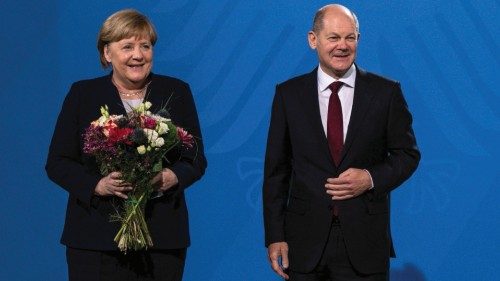 Newly elected German Chancellor Olaf Scholz and his predecessor Angela Merkel pose after Scholz gave ...
