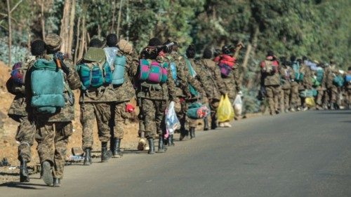 TOPSHOT - Soldiers of the Ethiopian National Defense Force (ENDF) walk along a road toward the ... TOPSHOT - Soldiers of the Ethiopian National Defense Force (ENDF) walk along a road toward the ...