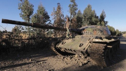 A boy sits on the barrel of a military tank destroyed recently during fighting between the Ethiopian ...