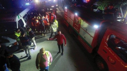 Ambulances and firefighting vehicles are seen outside the Palestinian camp after an explosion took ...