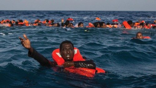 LAMPEDUSA, ITALY - MAY 24:  Refugees and migrants are seen swimming and yelling for assistance from ...