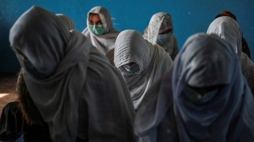 TOPSHOT - This picture taken on November 16, 2021 shows women sitting inside their classroom at ...