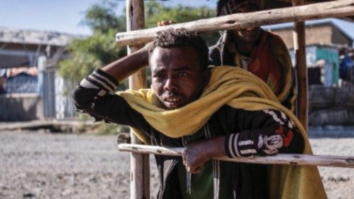 People stand in a shade in Mehal Meda, Ethiopia, on December 06, 2021. (Photo by Amanuel Sileshi / ...