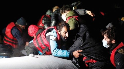 Migrants get on an inflatable dinghy as they leave the coast of northern France to cross the English ...