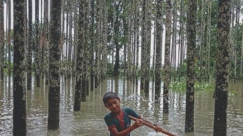 -- AFP PICTURES OF THE YEAR 2021 --A child wades through a flooded area using a makeshift raft at ...