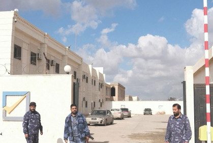 Security officers stand in front of the High National Election Commission building in Benghazi, ...