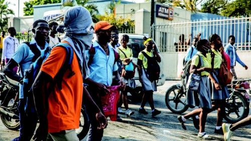 Students march through the Haitian capital Port-au-Prince on January 25, 2021 as they react to the ...