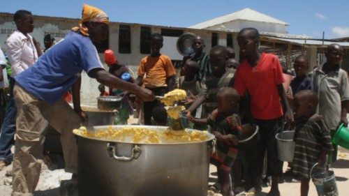 Somali children receive food ration at a feeding center in the southern Mogadishu district of ...