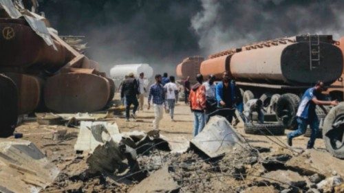 FILE - People are seen in front of clouds of black smoke from fires in the aftermath at the scene of ...