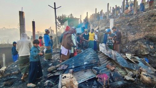 Rohingya refugees gather near their burnt shelters after a massive fire broke out at the Balukhali ...