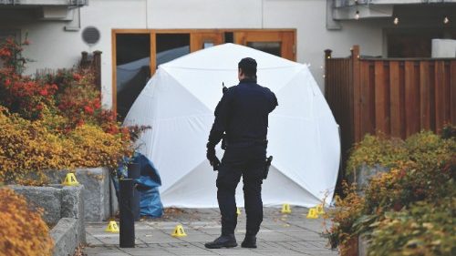 A police officer stands next to a crime scene at the Hammarby Sjostad district in Stockholm on ...