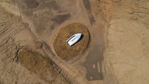 FILE PHOTO: A lone boat sits perched on a mound near Hensley Lake as soaring temperatures and ...